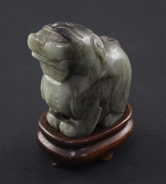 A Chinese pale grey and black jade carving of a lion-dog, Ming dynasty, 6cm., wood stand